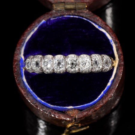 Victorian half hoop ring with five graduated old mine cut diamonds set in individual collet settings on an 18ct yellow gold band