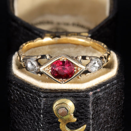 Georgian ruby and rose cut diamond ring in gold with closed-back settings and ornate shoulders, circa early 19th century