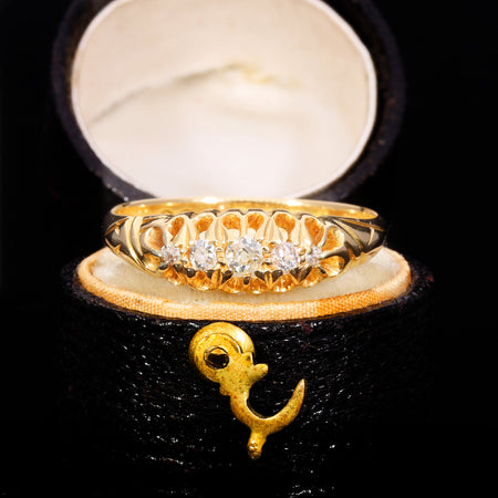 Edwardian five stone old cut diamond boat ring in 18ct yellow gold, dated 1907, with graduated diamonds in a navette-shaped carved collet setting