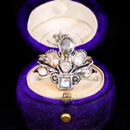 Georgian ring featuring multiple rose cut diamonds in a floral giardinetti arrangement, set in silver-topped gold with a tiara-shaped crown