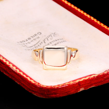 Antique Victorian square signet ring in gold with stepped shoulders and plain polished face, hallmarked 1865