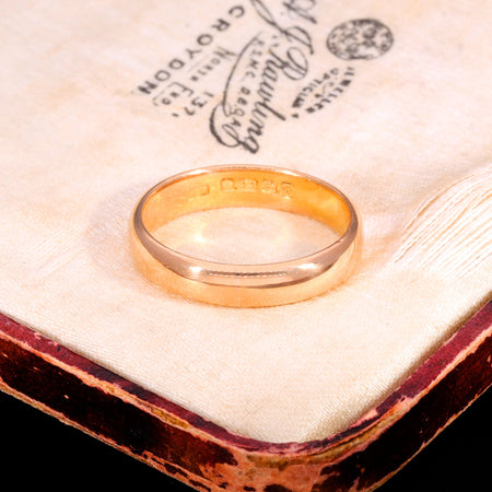 Antique Victorian 1849 22ct gold wedding ring showing hallmarks stamped inside the band, displayed on a jeweller's box